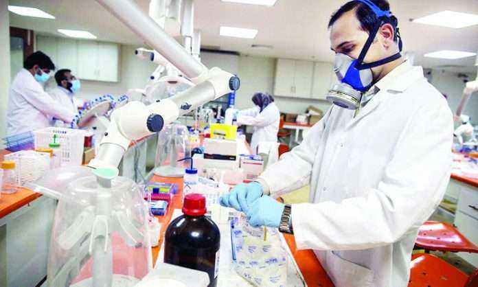 Forensic scientists analyze samples in the Toxicology department at Punjab Forensic Science Agency in Lahore