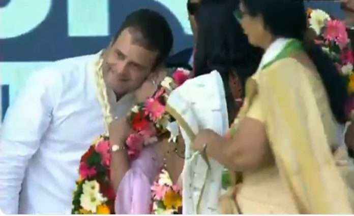 Woman kisses Rahul Gandhi on stage during Gujarat Valsad rally