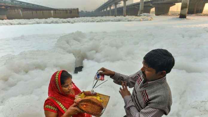 Husband and wife doing the rituals of Chhath Puja
