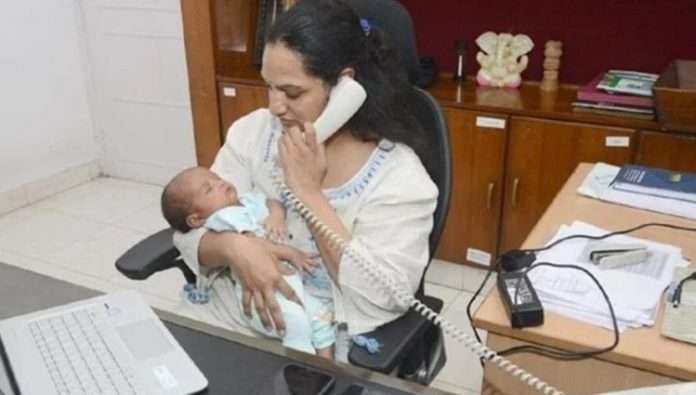 lady ias officer works with baby in hand courtecy - amar ujala